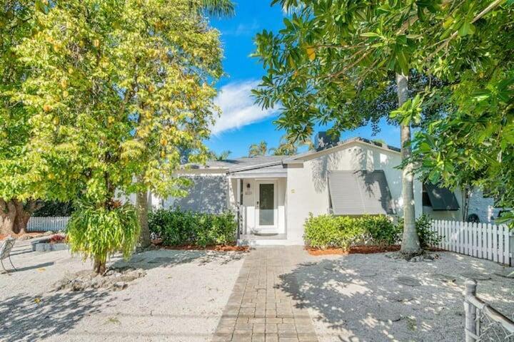 a front view of a house with a yard and potted plants