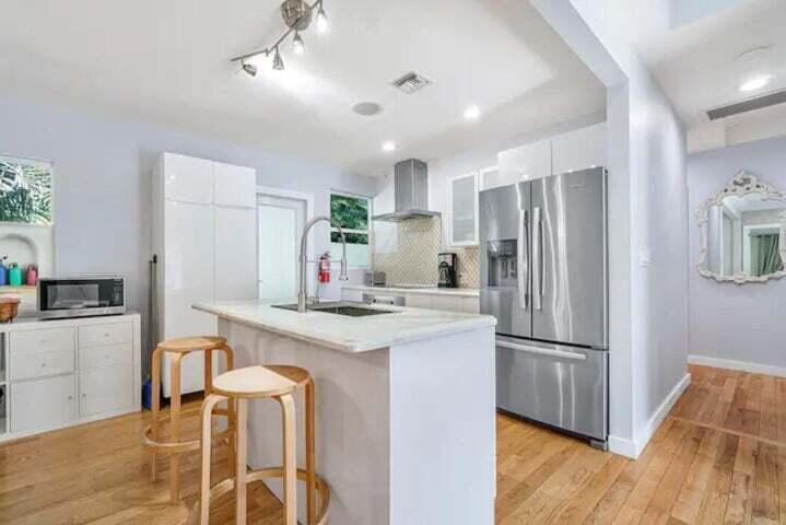11 Southwest 4th Street Delray Beach, FL 33444 - Photo 11 of 27 a kitchen with refrigerator cabinets and wooden floor