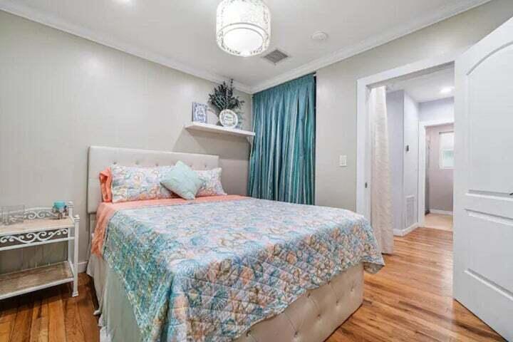 11 Southwest 4th Street Delray Beach, FL 33444 - Photo 15 of 27 a bedroom with a bed and a chandelier