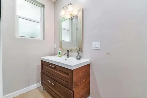 a bathroom with a sink vanity and a mirror