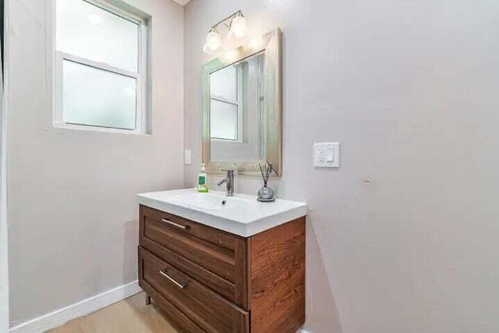 11 Southwest 4th Street Delray Beach, FL 33444 - Photo 19 of 27 a bathroom with a sink vanity and a mirror