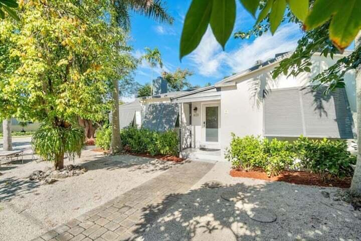 11 Southwest 4th Street Delray Beach, FL 33444 - Photo 2 of 27 a front view of a house with a yard and potted plants