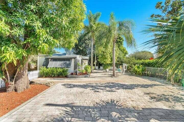 11 Southwest 4th Street Delray Beach, FL 33444 - Photo 23 of 27 a front view of a house with a yard and a garage