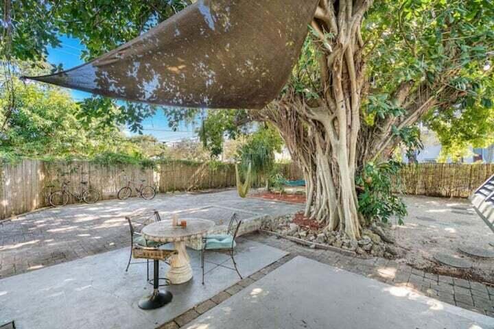 11 Southwest 4th Street Delray Beach, FL 33444 - Photo 26 of 27 a view of backyard with table and chairs and a large tree