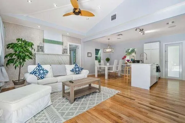 a living room with furniture and wooden floor