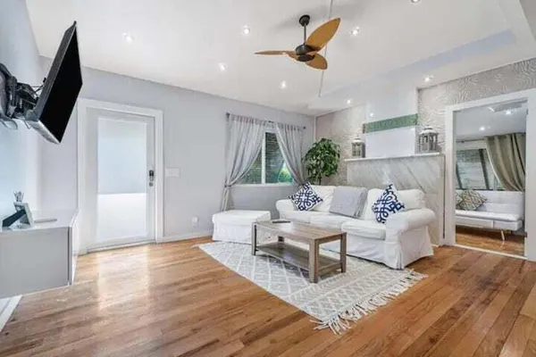 a living room with furniture and a flat screen tv