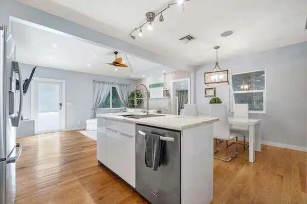 a kitchen with kitchen island a stove and a wooden floors