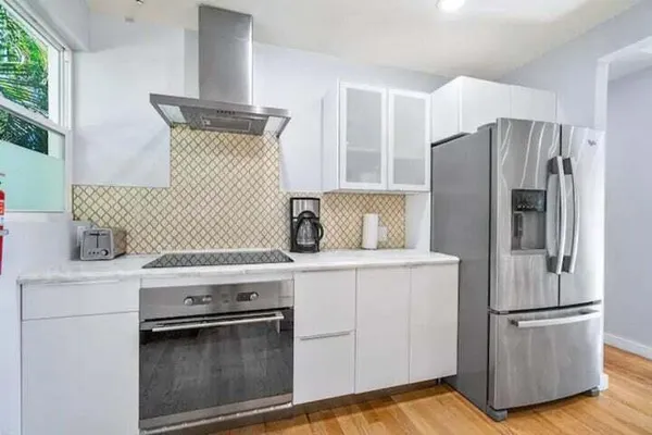 a kitchen with a stove a refrigerator and a sink