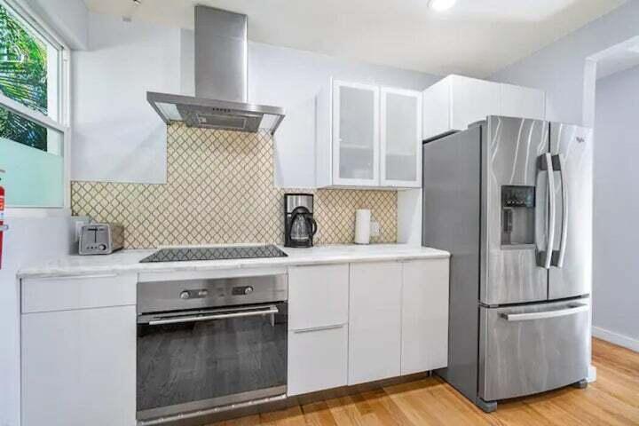 11 Southwest 4th Street Delray Beach, FL 33444 - Photo 10 of 27 a kitchen with a stove a refrigerator and a sink