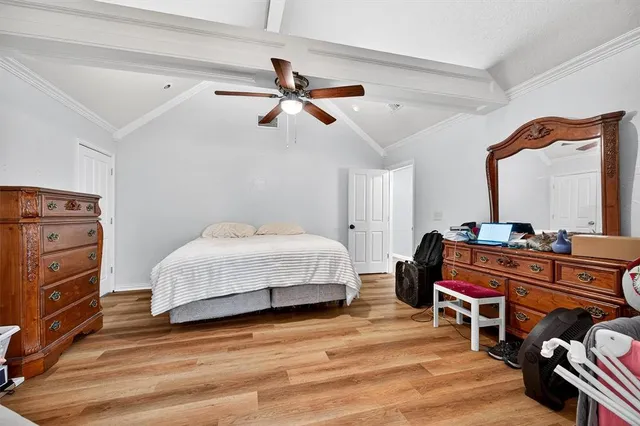 a bedroom with a bed and a dresser