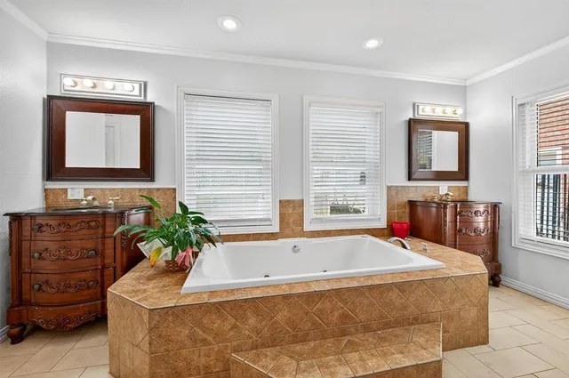 a bath tub sitting in a bathroom next to a window