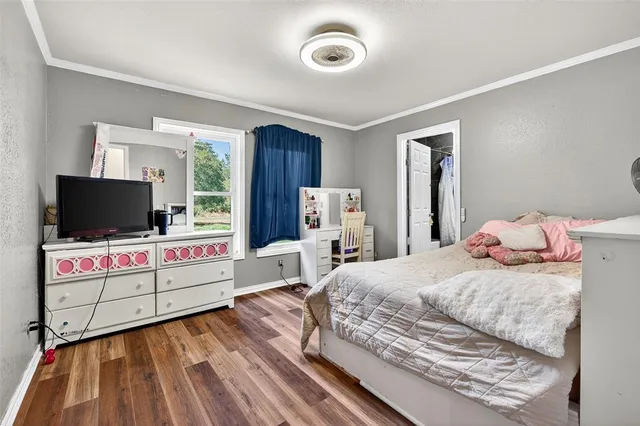 a bedroom with a bed and flat screen tv