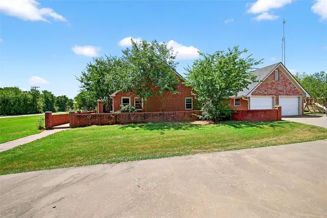 a front view of house with yard and green space