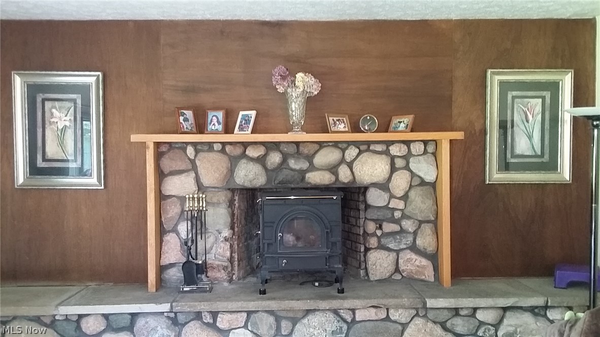 31400 Miles Road Solon, OH 44139 - Photo 5 of 16 Natural river rock, full masonry fireplace with raised hearth, gas starter, wood burning insert in family room.