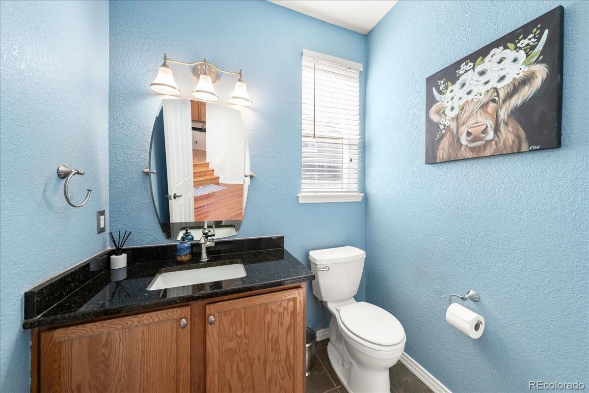 2730 River View Drive Broomfield, CO 80023 - Photo 13 of 48 a bathroom with a granite countertop toilet sink and mirror