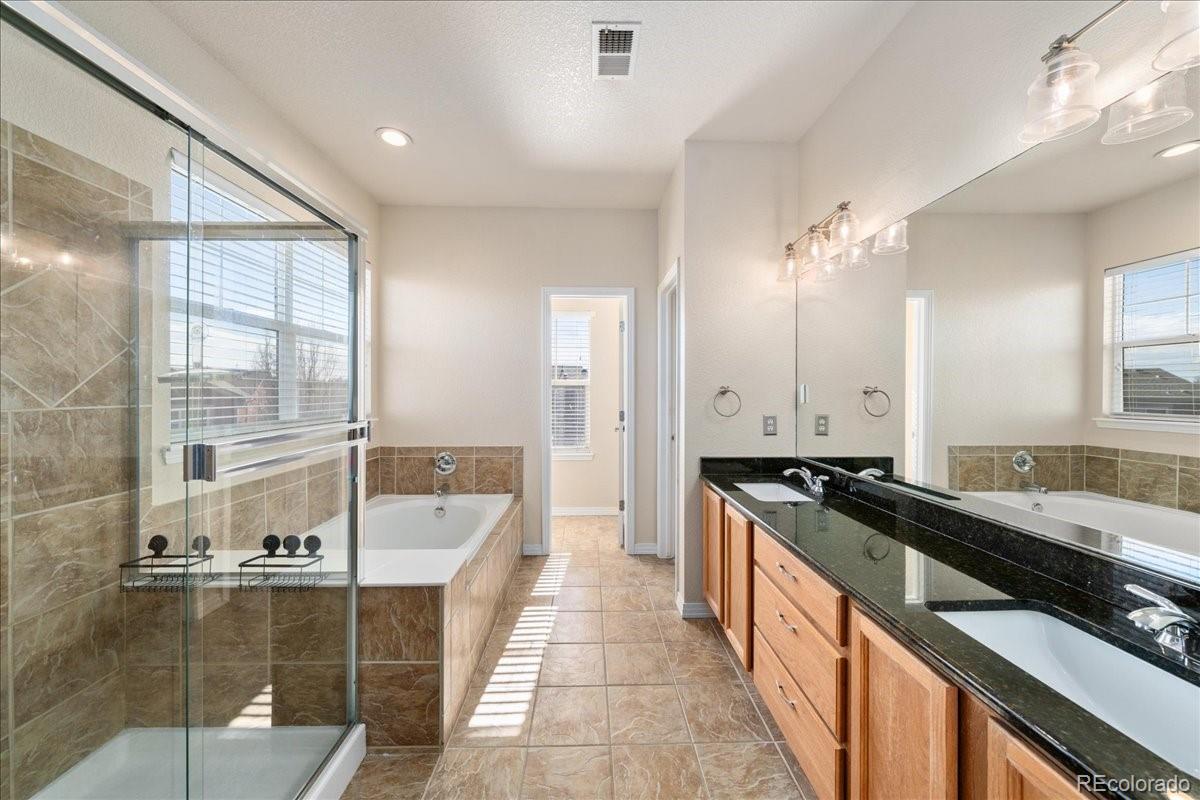 2730 River View Drive Broomfield, CO 80023 - Photo 18 of 48 a large kitchen with kitchen island granite countertop a sink and cabinets