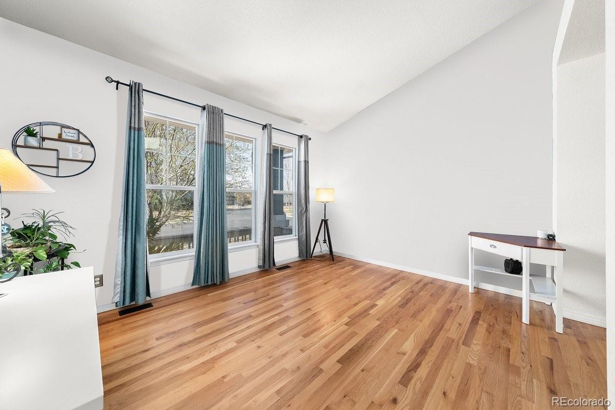 2730 River View Drive Broomfield, CO 80023 - Photo 2 of 48 a view of empty room with wooden floor and fan