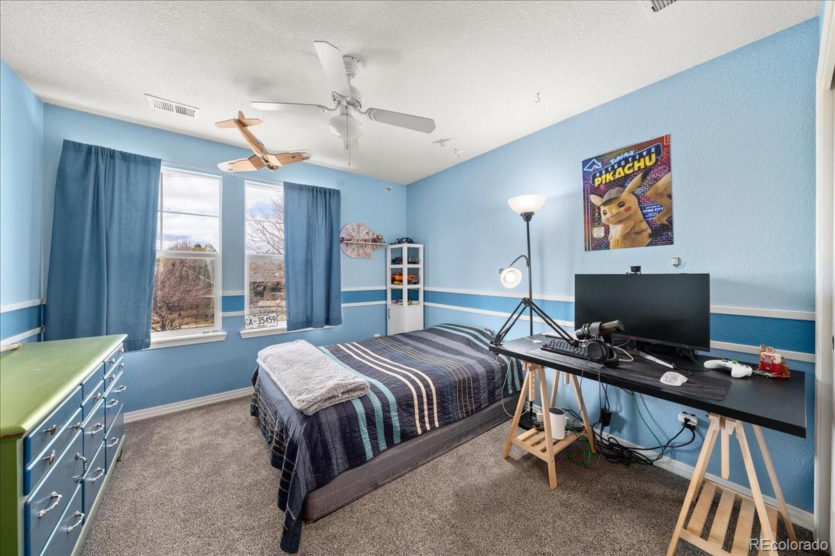 2730 River View Drive Broomfield, CO 80023 - Photo 22 of 48 a bedroom with a bed and a desk