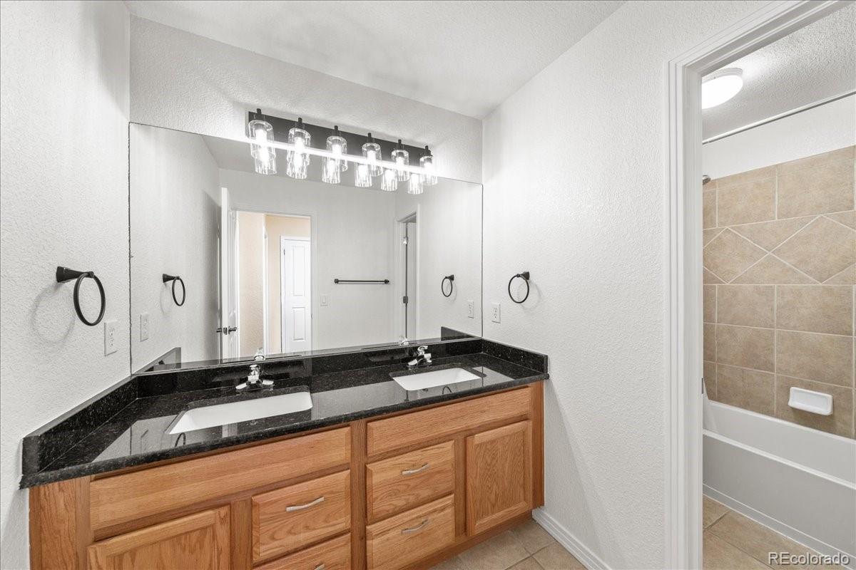 2730 River View Drive Broomfield, CO 80023 - Photo 23 of 48 a bathroom with a granite countertop sink and a mirror