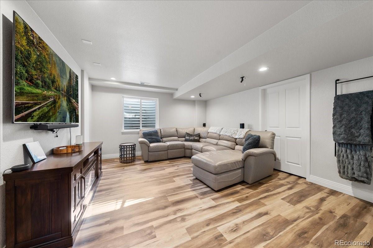 2730 River View Drive Broomfield, CO 80023 - Photo 27 of 48 a living room with furniture and a flat screen tv