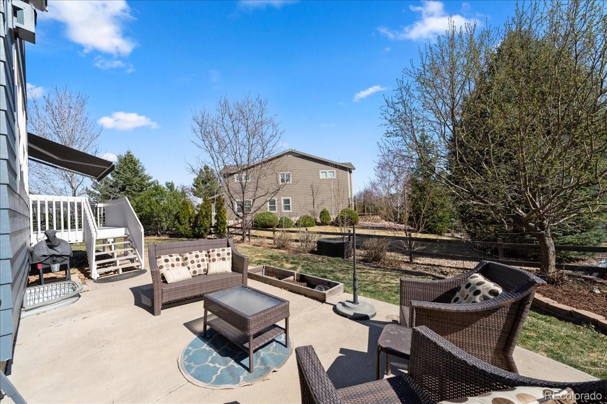 2730 River View Drive Broomfield, CO 80023 - Photo 41 of 48 a view of a patio with couches table and chairs with potted plants and a large tree