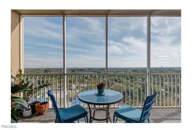 a view of a balcony with chairs and a table