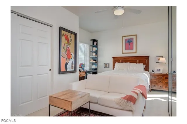 a bedroom with a bed and a painting on the wall