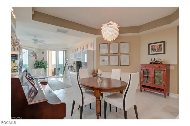 a view of a dining room with furniture and chandelier