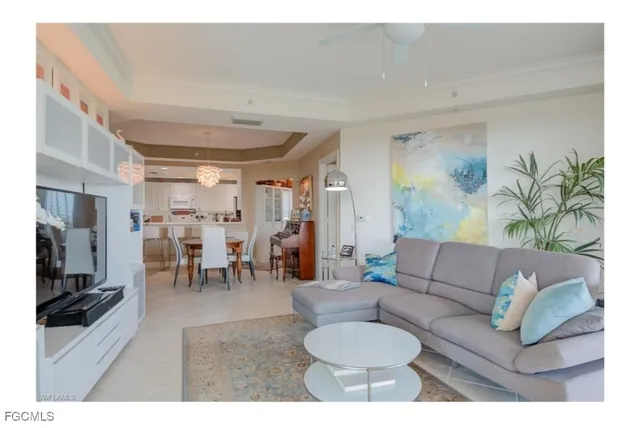 a living room with furniture and a dining table