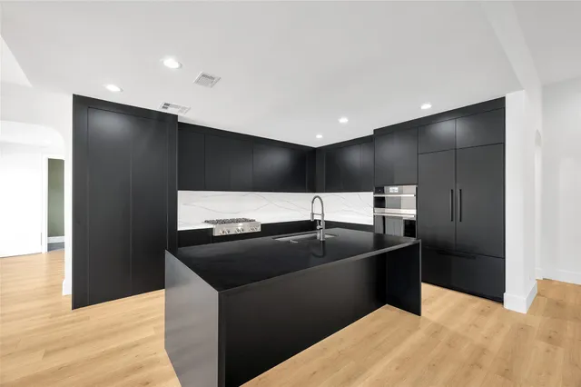 a kitchen with a sink and refrigerator