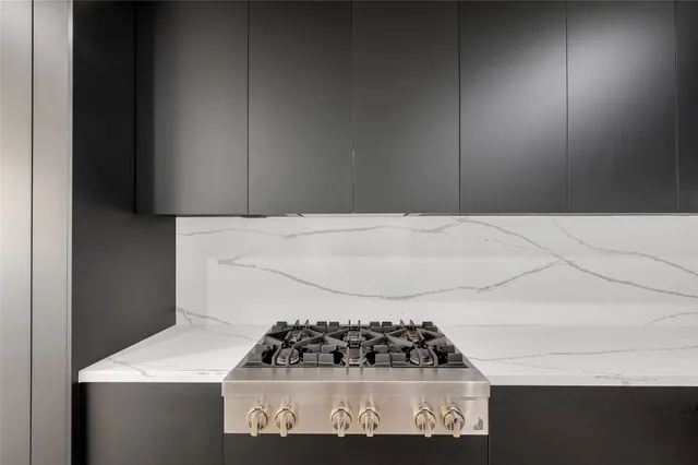 a kitchen with a stove and cabinets