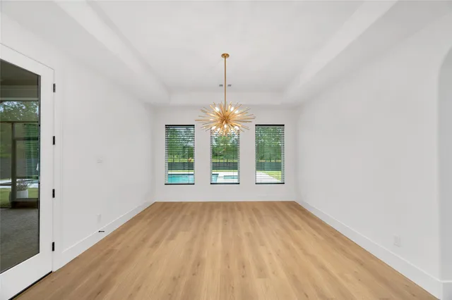 a view of a kitchen with a sink and a chandelier