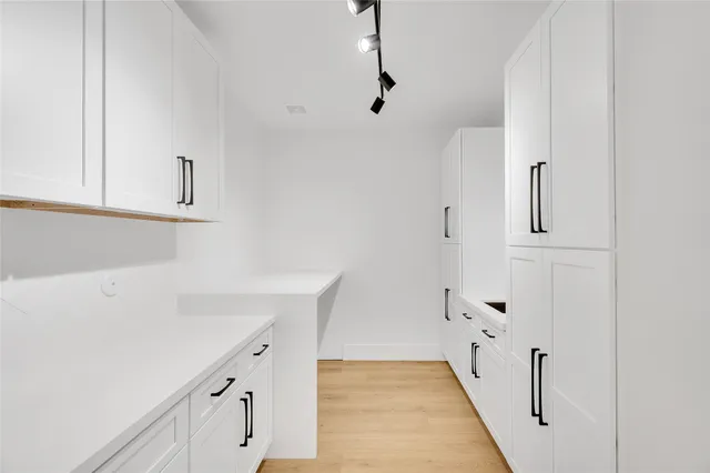a view of cabinets and wooden floor