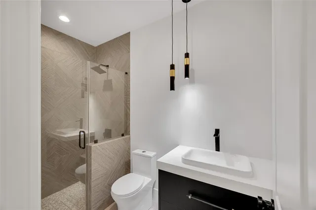 a view of a hallway with wooden floor and white wall