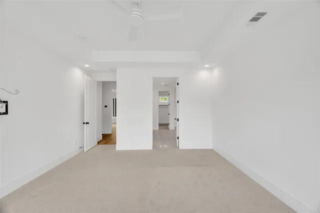 a bathroom with a granite countertop sink a toilet and shower