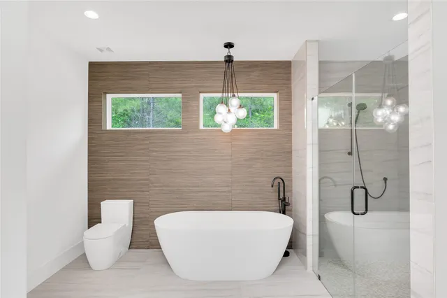 a spacious bathroom with a double vanity sink a mirror and a shower