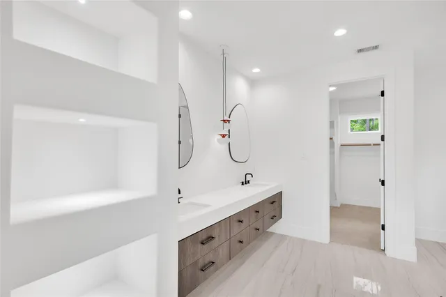 a bathroom with a double vanity sink and a mirror