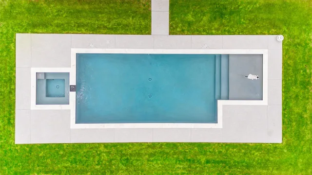 a view of a swimming pool with a yard