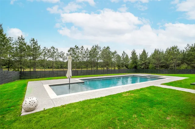 a view of swimming pool with a yard