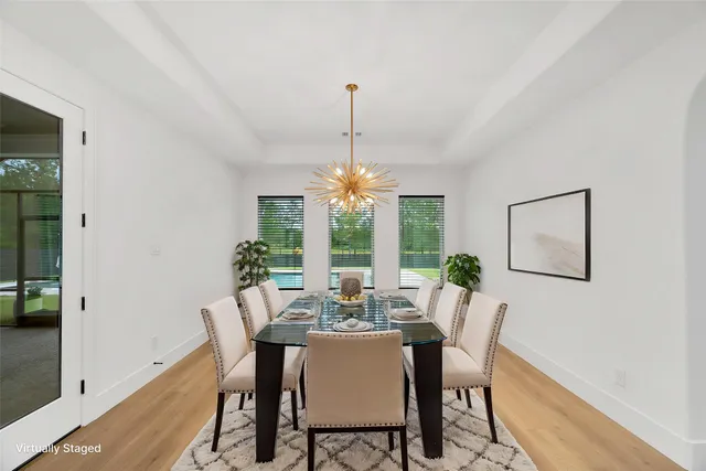 a dining room with furniture a chandelier and window