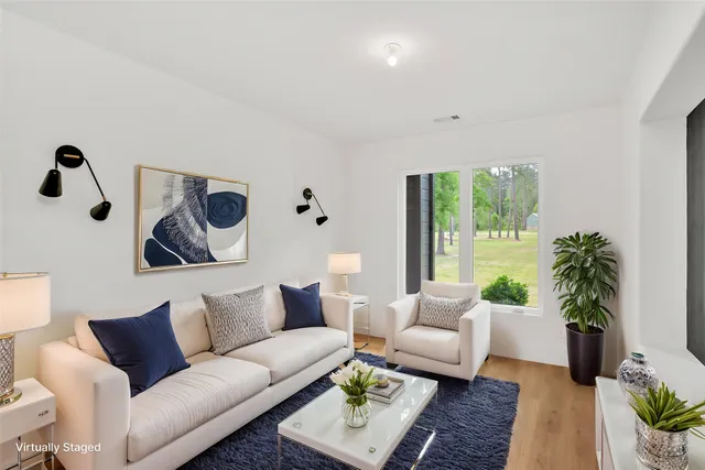 a living room with furniture and a large window