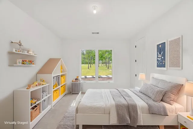 a bedroom with a bed and a window