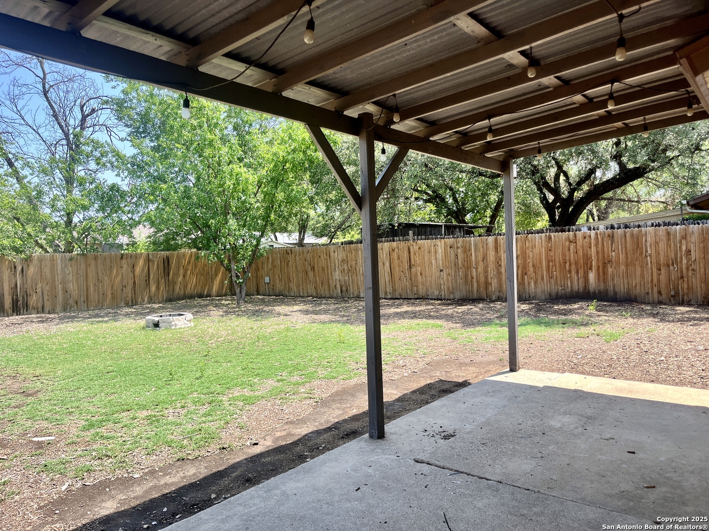 5019 Ed White Street Kirby, TX 78219 - Photo 14 of 15 a view of a backyard with wooden fence