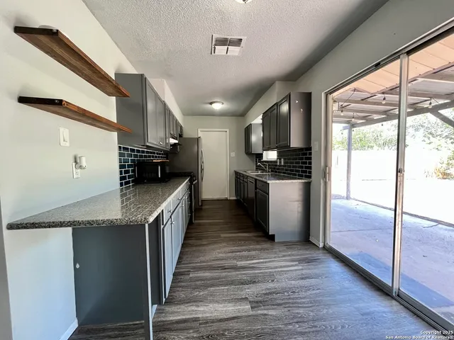 a kitchen with stainless steel appliances granite countertop a stove and a sink