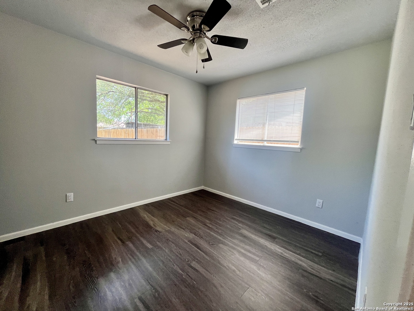 5019 Ed White Street Kirby, TX 78219 - Photo 7 of 15 a view of an empty room with a window and wooden floor