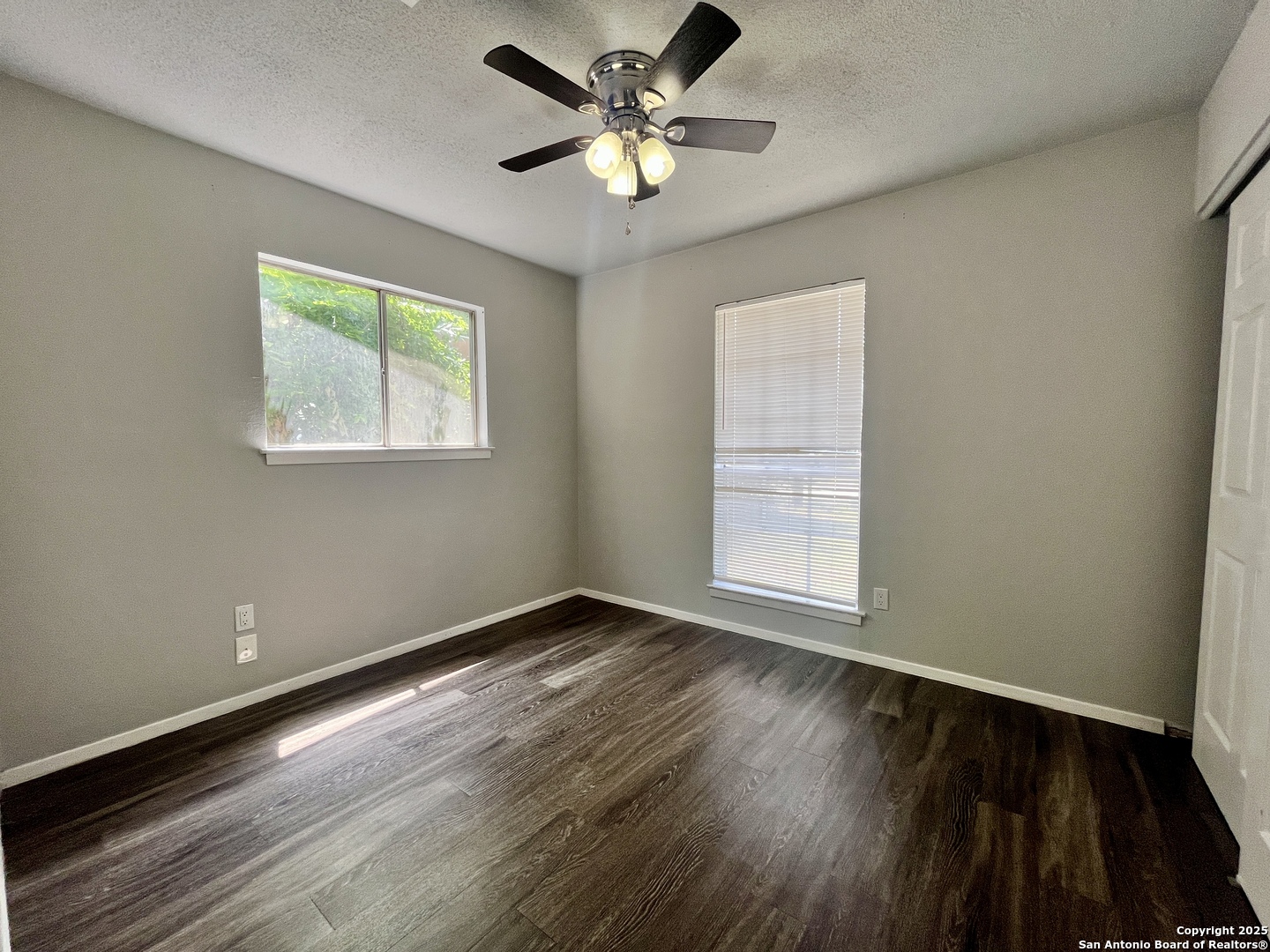 5019 Ed White Street Kirby, TX 78219 - Photo 8 of 15 a view of an empty room with window and wooden floor