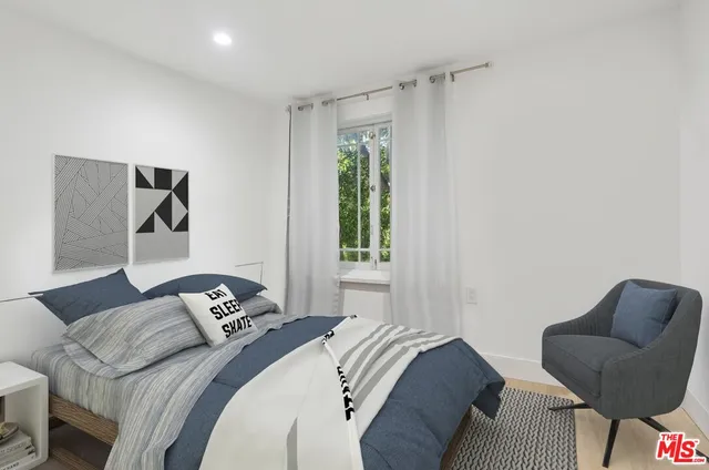 a bedroom with a bed and a couch