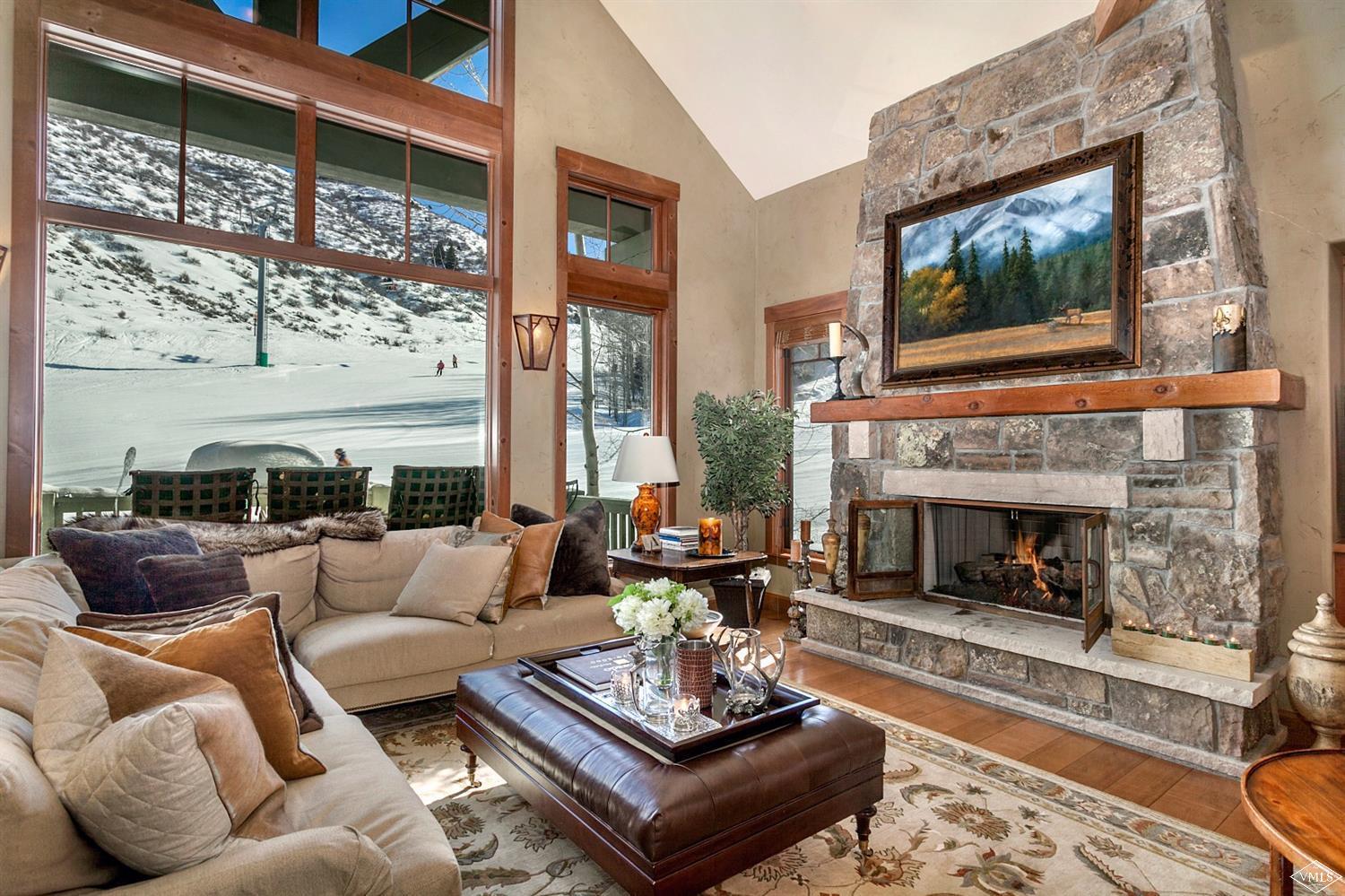a living room with furniture large window and a fireplace