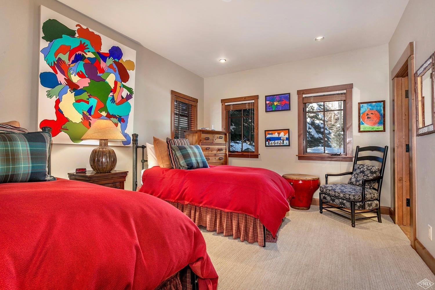 348 Cresta Road Edwards, CO 81632 - Photo 19 of 25 a bedroom with three beds and painting on the wall