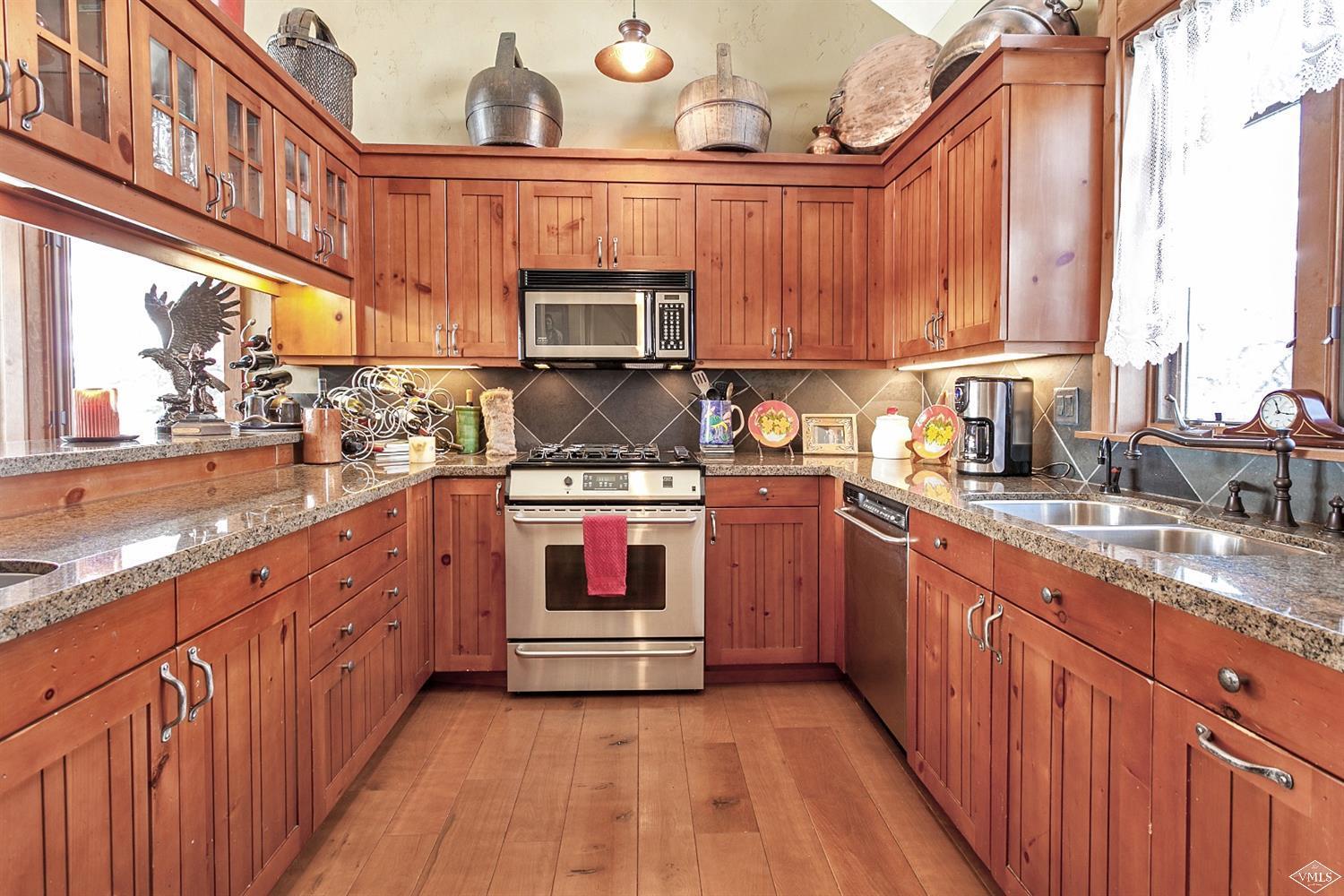 348 Cresta Road Edwards, CO 81632 - Photo 9 of 25 a kitchen with stainless steel appliances a stove and cabinets